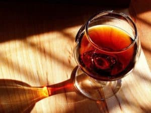 An elegant glass of wine under sunlight.