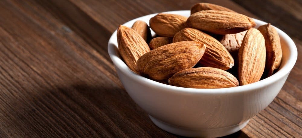 A handful of almonds in a cup.