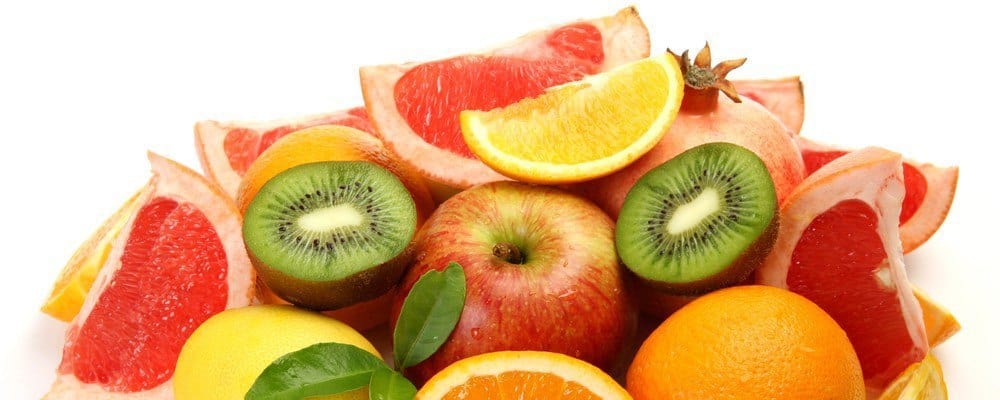 A bunch of sliced fruit (oranges, apples, kiwis).