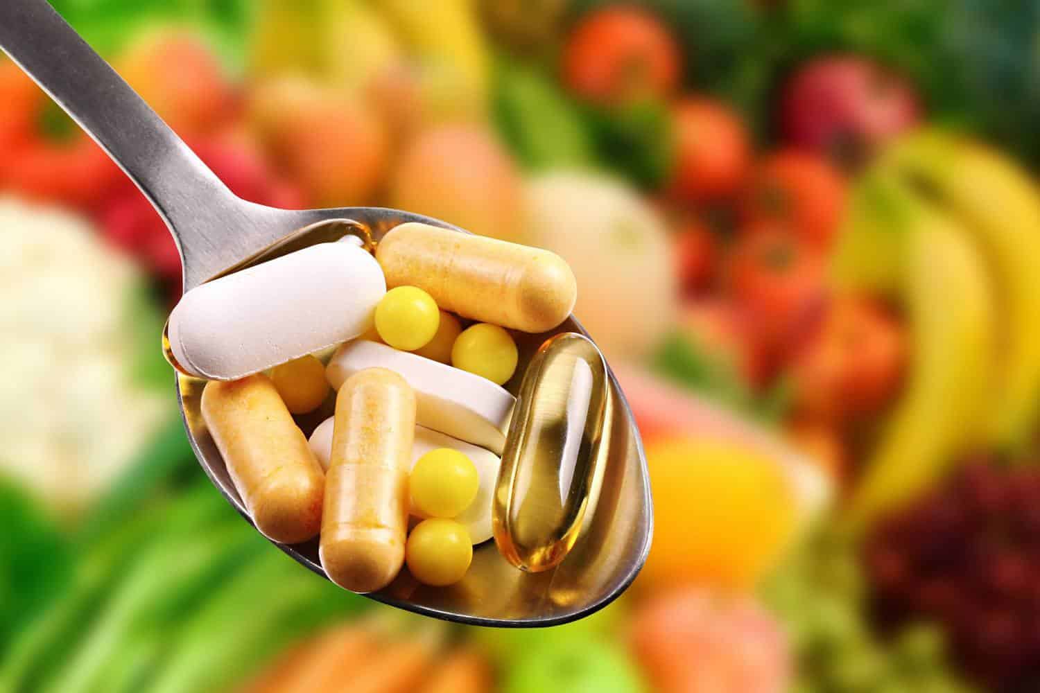 A spoonful of vitamin capsules.