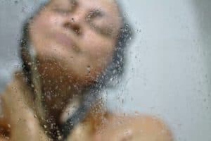Reflection of a woman in the shower.
