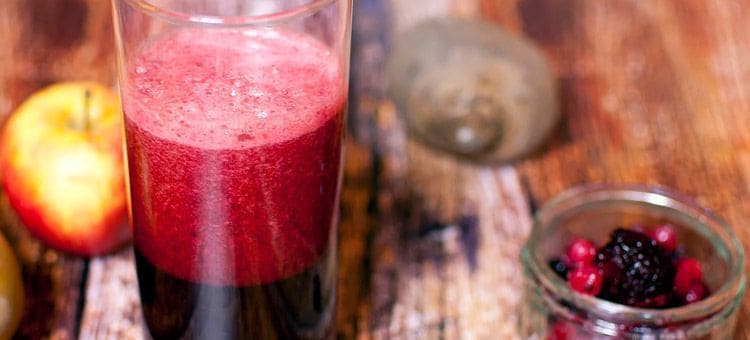 A glass of beet apple berry juice.