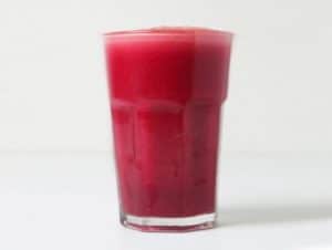A glass of beet and celery juice.