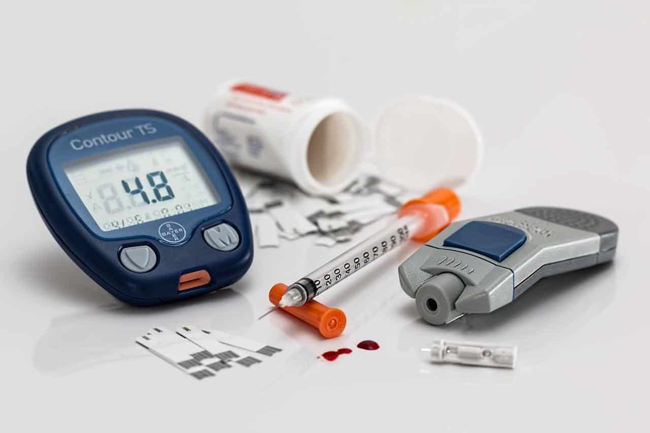 Various tools used by diabetes patients like insulin and a blood sugar monitor.