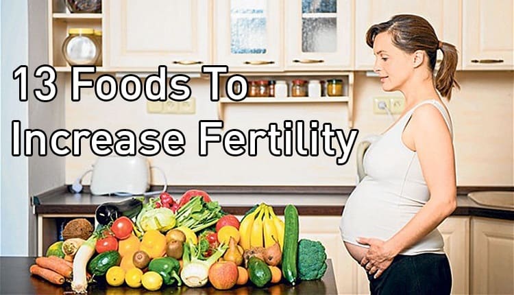 A pregnant woman standing next to a table with the title "13 Foods To Increase Fertility."