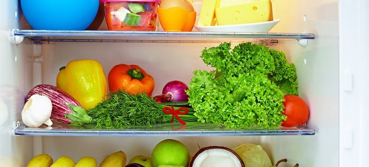 A fridge full of fruit and vegetables.