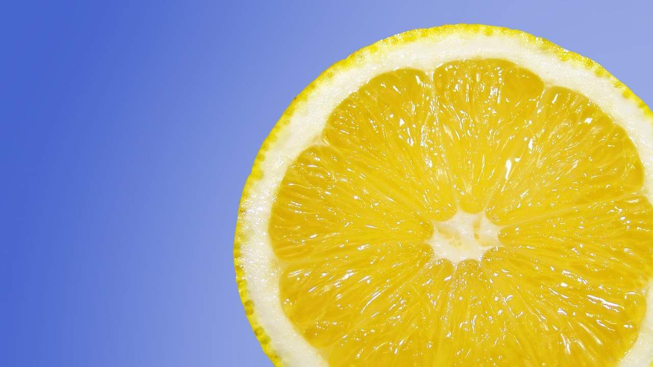 A slice of lemon with a blue background.
