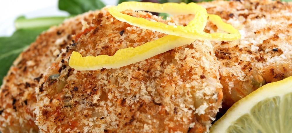 Close-up of salmon patties decorated with a few slices of lemon.
