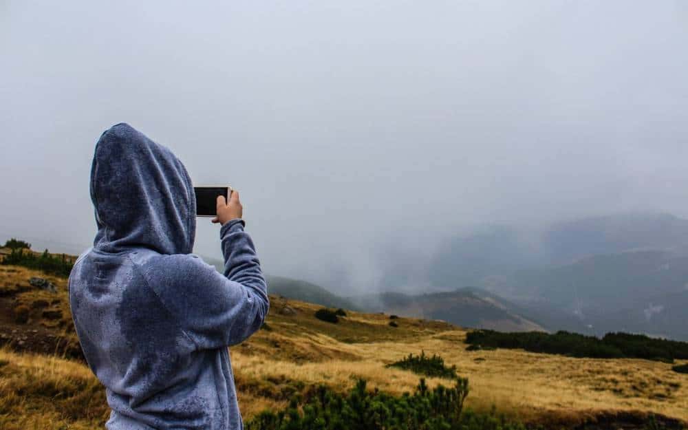 A person taking a photo during a hike.