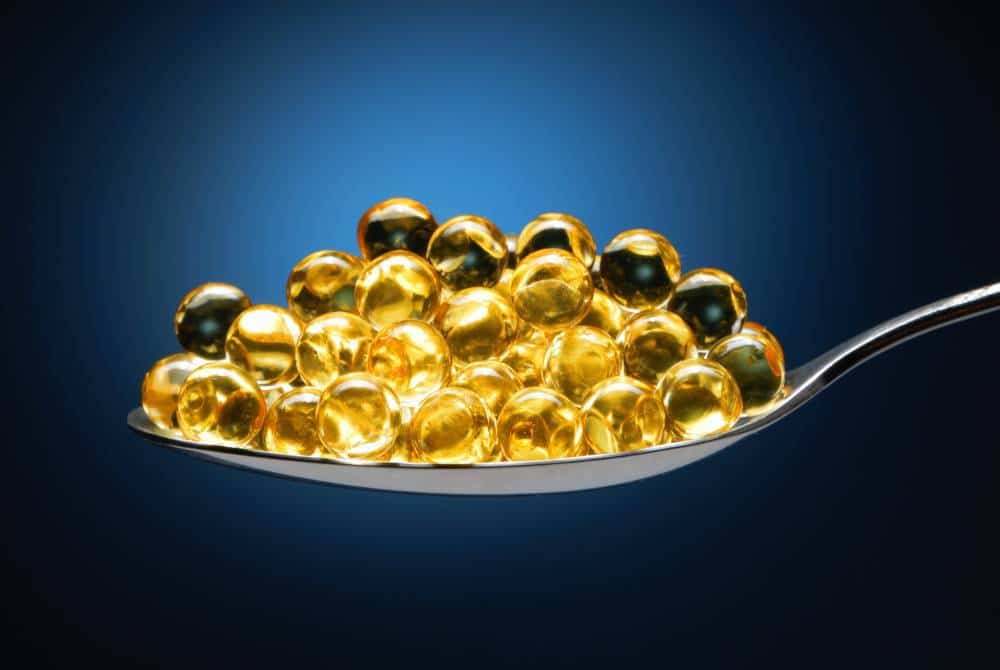 A spoonful of fish oil capsules.
