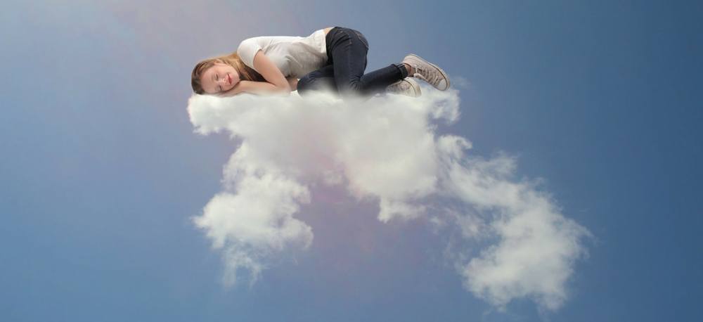A person sleeping on a cloud.