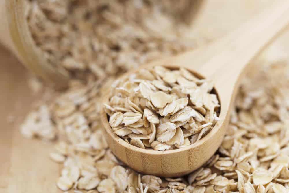 A Healthy Dry Oat meal in a wooden spoon