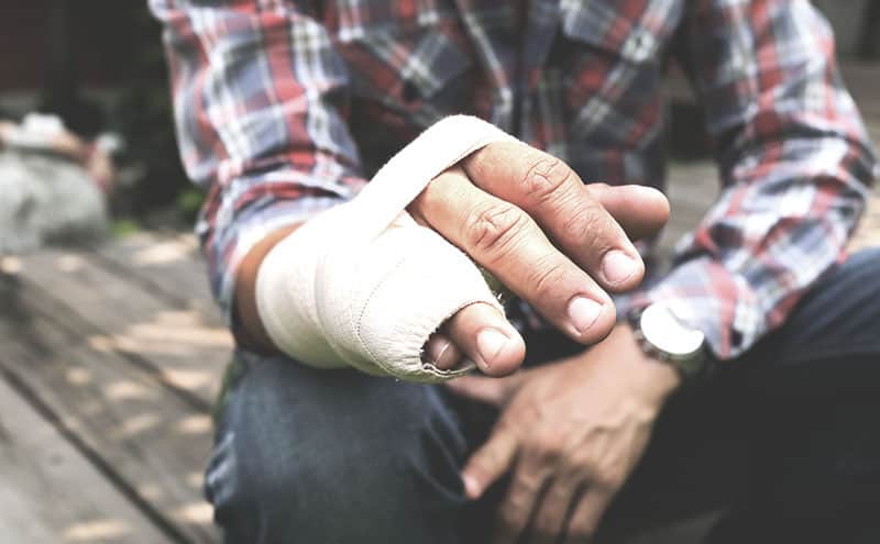 A man with finger splints for broken finger injuries.